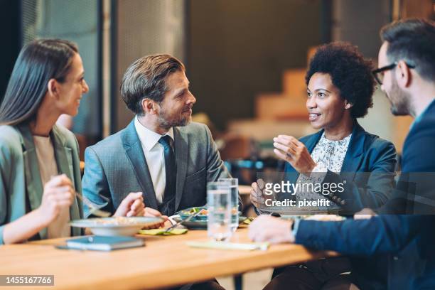 business people in a restaurant - formal businesswear stock pictures, royalty-free photos & images
