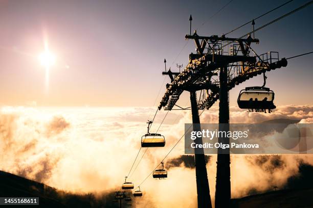 cable car on mountain background and cloudy landscape during sunset. - krasnaïa poliana sotchi photos et images de collection