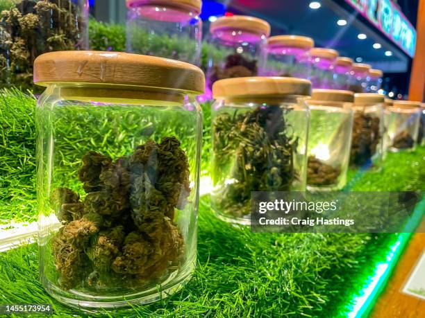 cannabis in glass jars for sale on the streets of bangkoks night markets and tourist areas. the thai government are relaxing laws on the intoxicating drug substance. bangkok thailand - cannabis store stockfoto's en -beelden