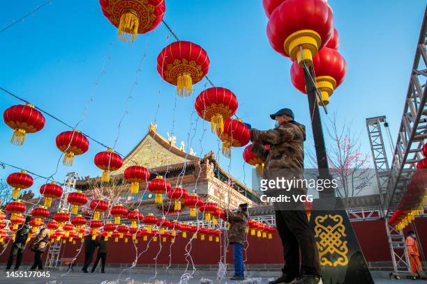 Workers hang red lanterns at a pedestrian street ahead of Chinese New Year, the Year of the Rabbit, on January 9, 2023 in Hohhot, Inner Mongolia...