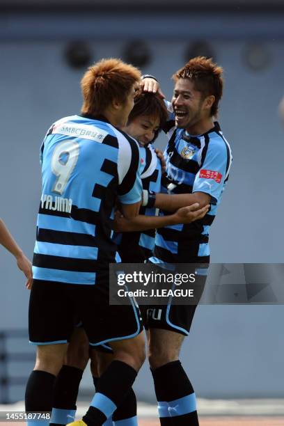 Yu Kobayashi of Kawasaki Frontale celebrates with teammates Takuro Yajima and Yusuke Tanaka after scoring the team's first goal during the J.League...