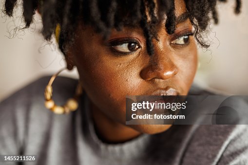 Young woman looking away, contemplating her New Year's resolutions Young woman looking away, contemplating her New Year's resolutions