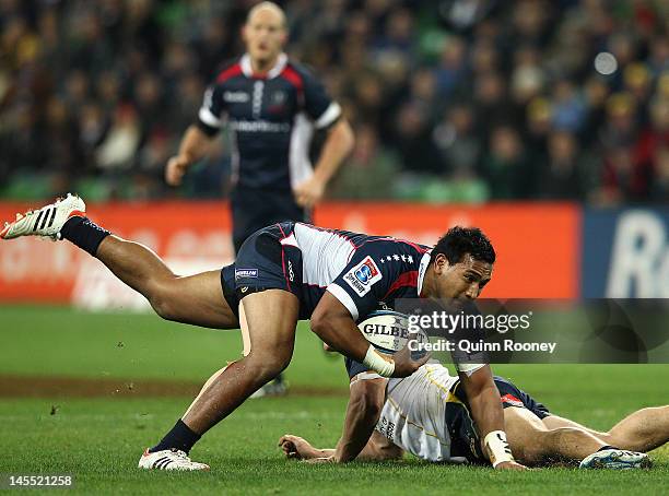 Cooper Vuna of the Rebels breaks through a tackle during the round 15 Super Rugby match between the Rebels and the Brumbies at AAMI Park on June 1,...