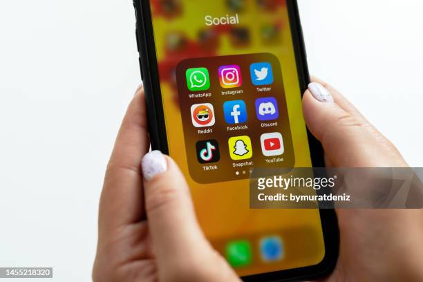 social media app on smartphone mobile online application - holding iphone stockfoto's en -beelden