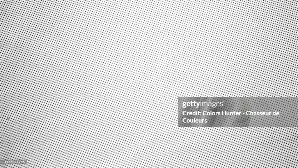 Very close-up of a poster in white and grey tones printed using the offset technique in Paris