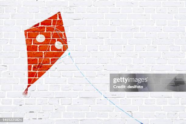 white brick wall grunge grunge textured effect wall with graffiti of one big dark vibrant red colour solid three dimensional abstract flying kite with string with copy space for text - makar sankranti 幅插畫檔、美工圖案、卡通及圖標