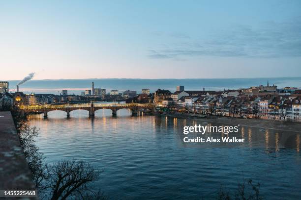 mittlere brücke (middle bridge) illuminated with reflections in basel, switzerland. - skyline basel fotografías e imágenes de stock