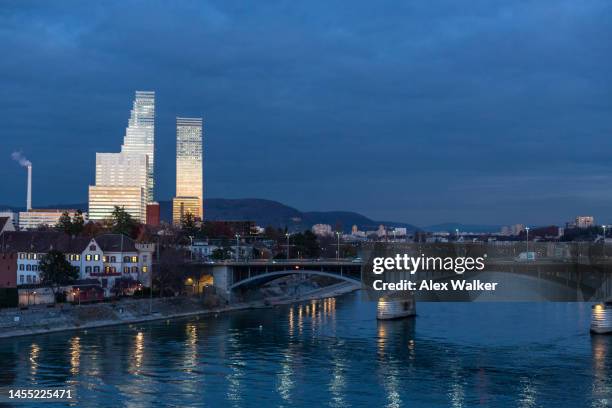 historic and modern buildings of the wettstein district glow at night in basel, switzerland. - skyline basel stockfoto's en -beelden