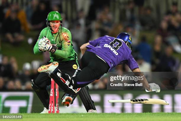 Joe Clarke of the Stars runs out Tim David of the Hurricanes during the Men's Big Bash League match between the Hobart Hurricanes and the Melbourne...