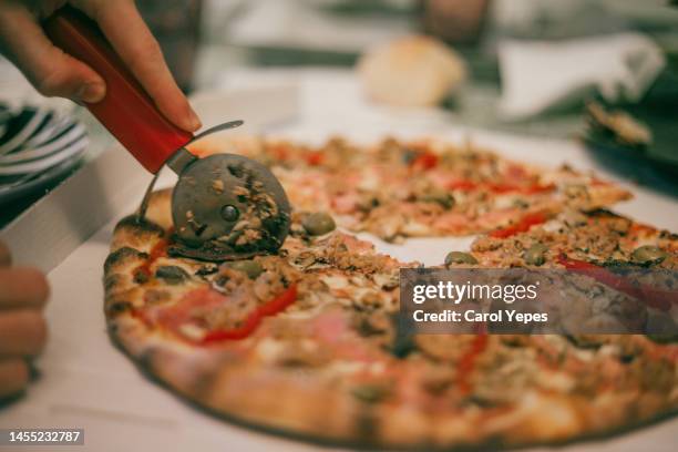 kid han grabbing a slice of pizza from table - pizza stand stock pictures, royalty-free photos & images