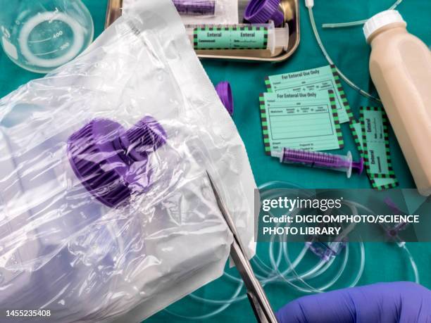 nurse opening bottle of enteral nutrition, conceptual image - antioxidant support stock pictures, royalty-free photos & images