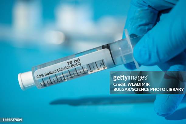 saline syringe - injecting iv stock pictures, royalty-free photos & images