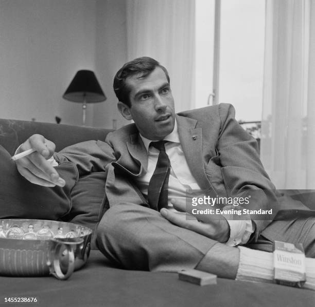 French film director Roger Vadim smoking a cigarette while resting a broken ankle at home on August 30th, 1960. Vadim broke his right ankle during a...