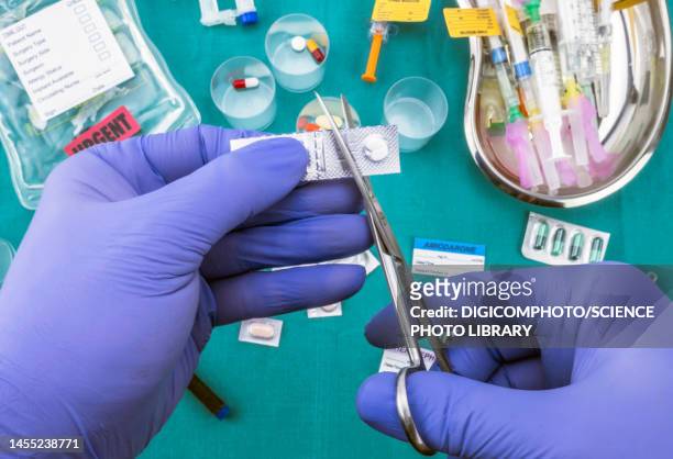 nurse cutting a blister of pills with scissors - injecting iv stock pictures, royalty-free photos & images