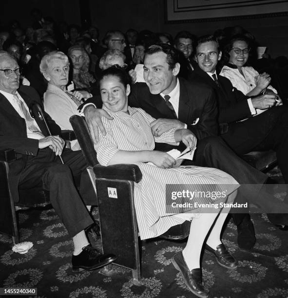 American actor Sam Wanamaker puts an arm around his daughter Zoe Wanamaker, aged 11, on August 22nd, 1960. British singer Dennis Lotis sits to the...