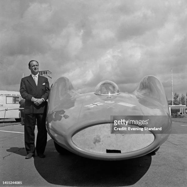 British speed record breaker Donald Campbell posing next to his Bluebird-Proteus CN7 car at Goodwood Circuit in Sussex on July 18th, 1960.