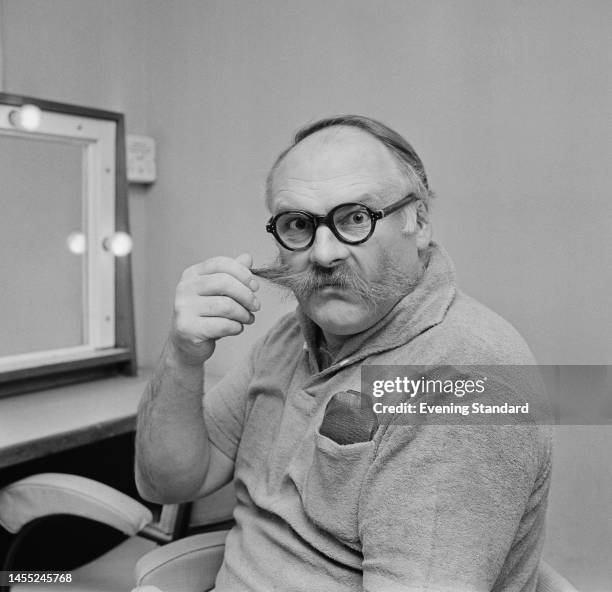 British comedy actor Jimmy Edwards twirling his trademark moustache in his dressing room on November 1st, 1961. (Photo by Evening Standard/Hulton...