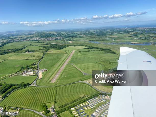 aerial view of bembridge, a small airfield surrounded by fields in the isle of wight, uk - rural banking stock-fotos und bilder