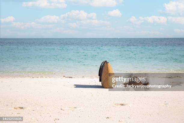 sunglass, sun hat and beach bag on white sand beach in tropical beach in thailand - blue white summer hat background stock pictures, royalty-free photos & images