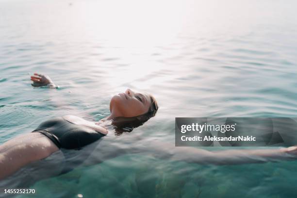 true relaxation - floating on water stock pictures, royalty-free photos & images