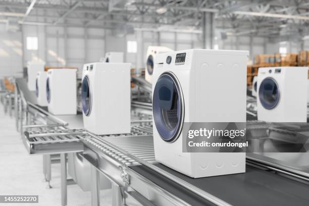 close-up view of washing machines on conveyor belt in warehouse - eletrodoméstico imagens e fotografias de stock