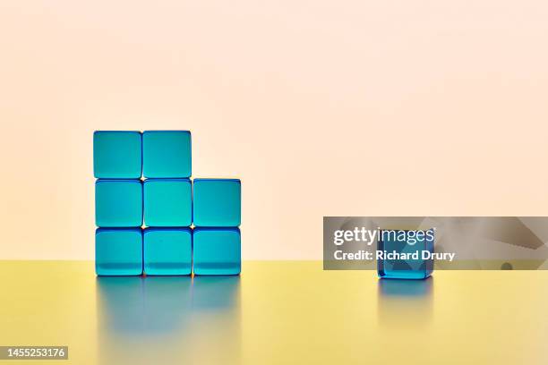 conceptual image of transparent coloured cubes - achievement gap stock pictures, royalty-free photos & images