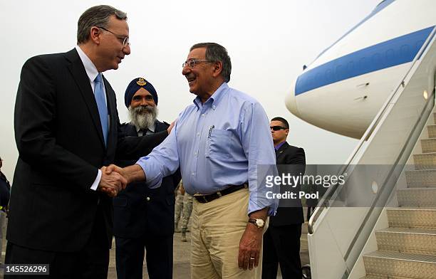 Secretary Of Defense Leon Panetta is watched by Commander Air Power Generation Command Colonel Sarbjit Singh as he shakes hands with US Ambassador to...