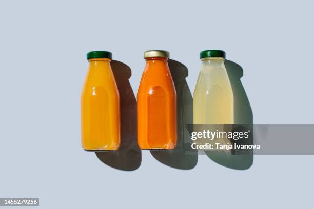 various of colorful smoothies or juices bottles beverages drinks on blue background. superfoods, healthy food, drinks, diet and detox concept. flat lay, top view - detox bildbanksfoton och bilder