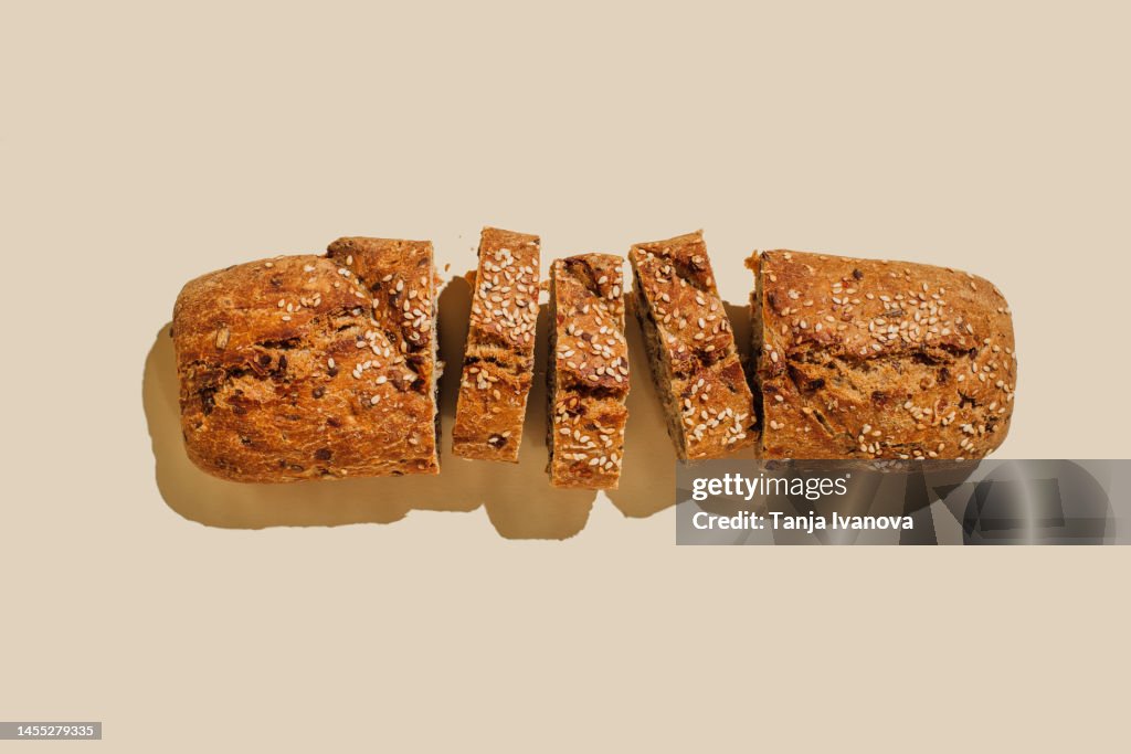 Sliced bread on beige background. Flat lay, top view, copy space