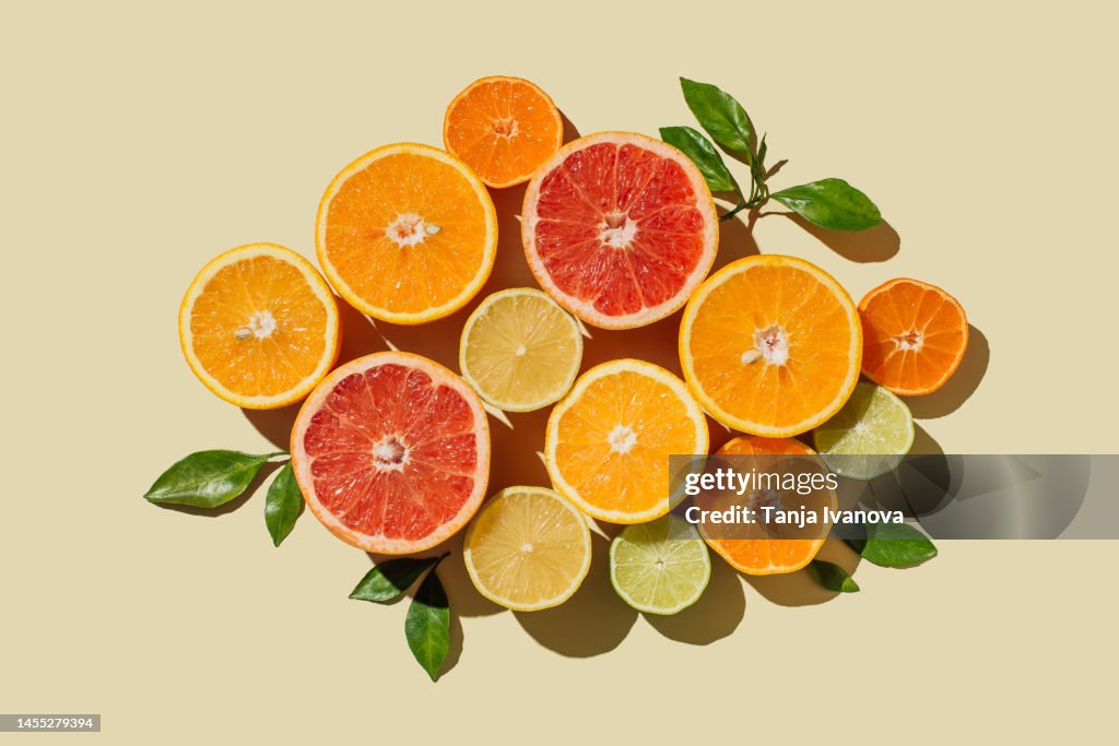 Pattern of slices citrus-fruit of Lemons, oranges, grapefruit, lime on beige background. Healthy food, diet and detox concept. Flat lay, top view