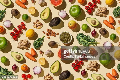 Pattern of variety fresh of organic fruits and vegetables and healthy vegan meal ingredients on beige background. Healthy food, clean eating, diet and detox, eco friendly, no plastic concept . Flat lay, top view Pattern of variety fresh of organic fruits and vegetables and healthy vegan meal ingredients on beige background. Healthy food, clean eating, diet and detox, eco friendly, no plastic concept . Flat lay, top view