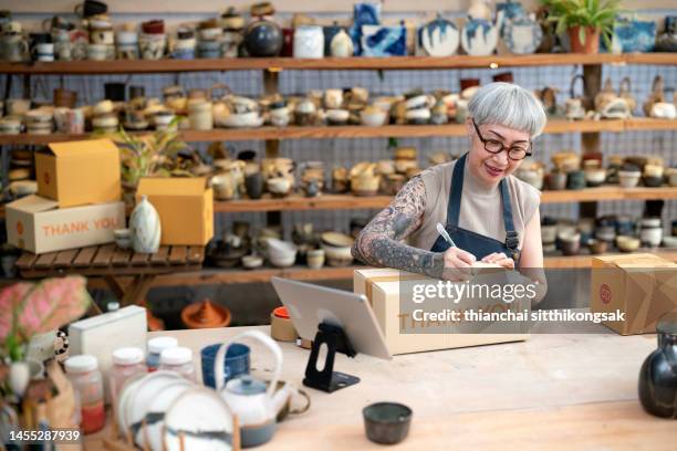 art and craft product owner writting customer information on paper box, preparing to deliver to customer - thank you post it stock pictures, royalty-free photos & images