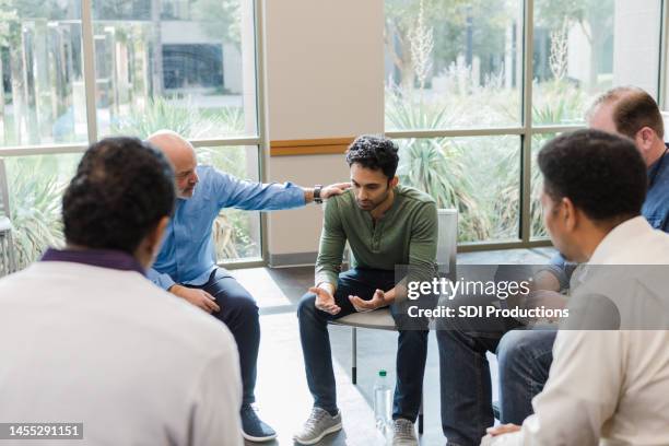 mature man consoles his friend - addiction stock pictures, royalty-free photos & images