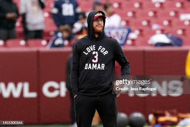 Carson Wentz of the Washington Commanders wears a shirt in support of Buffalo Bills safety Damar Hamlin prior to the game against the Dallas Cowboys...