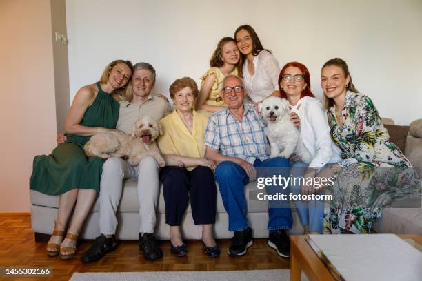 group portrait of big, happy family smiling at camera - large family bildbanksfoton och bilder