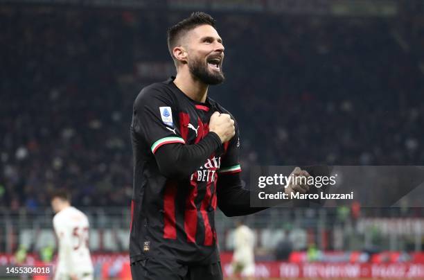 Olivier Giroud of AC Milan celebrates his team-mates goal during the Serie A match between AC Milan and AS Roma at Stadio Giuseppe Meazza on January...