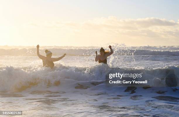 winter swimming in the sea at sunrise - surprise friend stock pictures, royalty-free photos & images