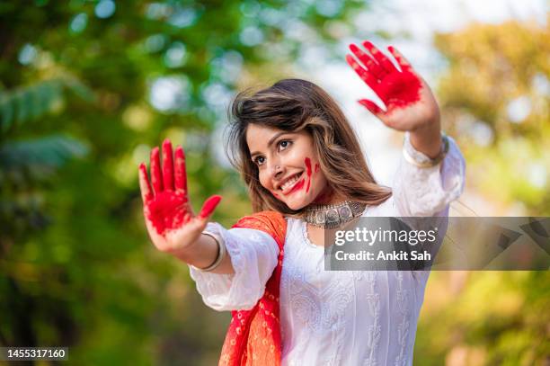 a beautiful girl celebrating holi with colours - holi portraits stock pictures, royalty-free photos & images