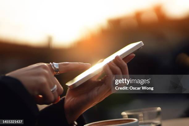 close-up of female hand touching phone screen - technology or innovation photos et images de collection