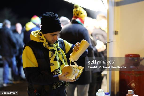 An Oxford United fan enjoys a meal prior to the Emirates FA Cup Third Round match between Oxford United and Arsenal at Kassam Stadium on January 09,...