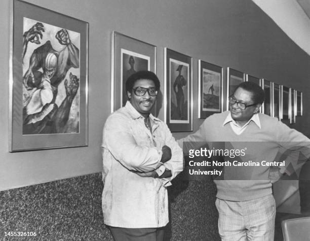 Artist, actor, author and American professional football player Ernie Barnes and Charles Stanback pose for the camera at North Carolina Central...