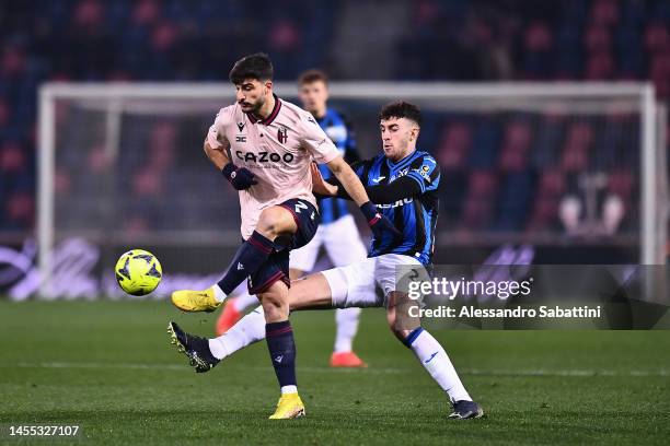 Riccardo Orsolini of Bologna FC battles for possession with Matteo Ruggeri of Atalanta BC during the Serie A match between Bologna FC and Atalanta BC...