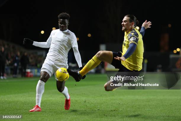 Ciaron Brown of Oxford United clears a shot from Bukayo Saka of Arsenal during the Emirates FA Cup Third Round match between Oxford United and...