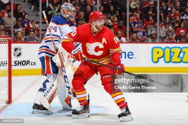 Jonathan Huberdeau of the Calgary Flames battles against Stuart Skinner of the Edmonton Oilers at Scotiabank Saddledome on December 27, 2022 in...