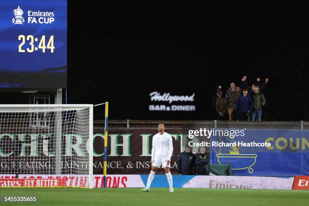 Fans watch match action from outside the stadium during the Emirates FA Cup Third Round match between Oxford United and Arsenal at Kassam Stadium on...