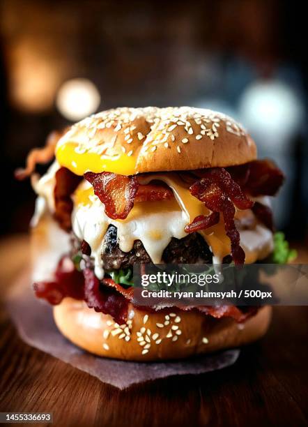close-up of burger on table - gourmet hamburger stock pictures, royalty-free photos & images