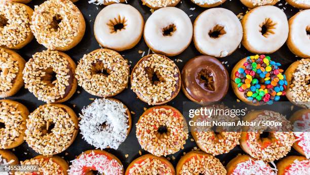 colorful doughnuts with sprinkles and topping,pakistan - dónute imagens e fotografias de stock