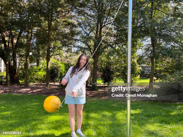 smiling girl playing tetherball - tether ball stock pictures, royalty-free photos & images