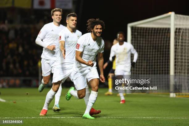 Mohamed Elneny of Arsenal celebrates with teammates Granit Xhaka and Rob Holding of Arsenal after scoring the team's first goal during the Emirates...