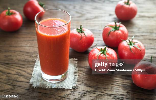 high angle view of tomatoes with juice on table,romania - tomato juice stock pictures, royalty-free photos & images